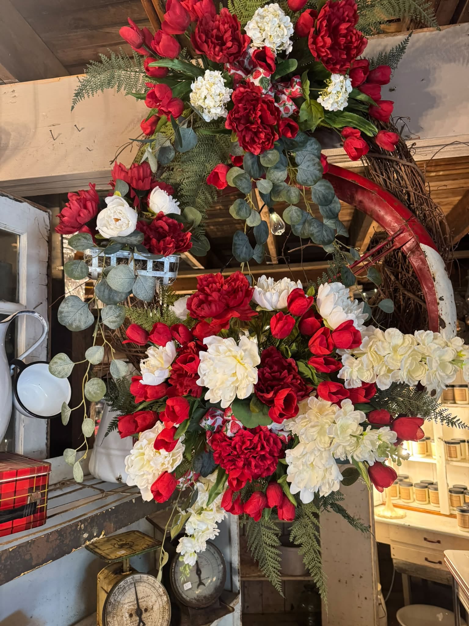 Red and white floral display photographed at Pearls & Lace